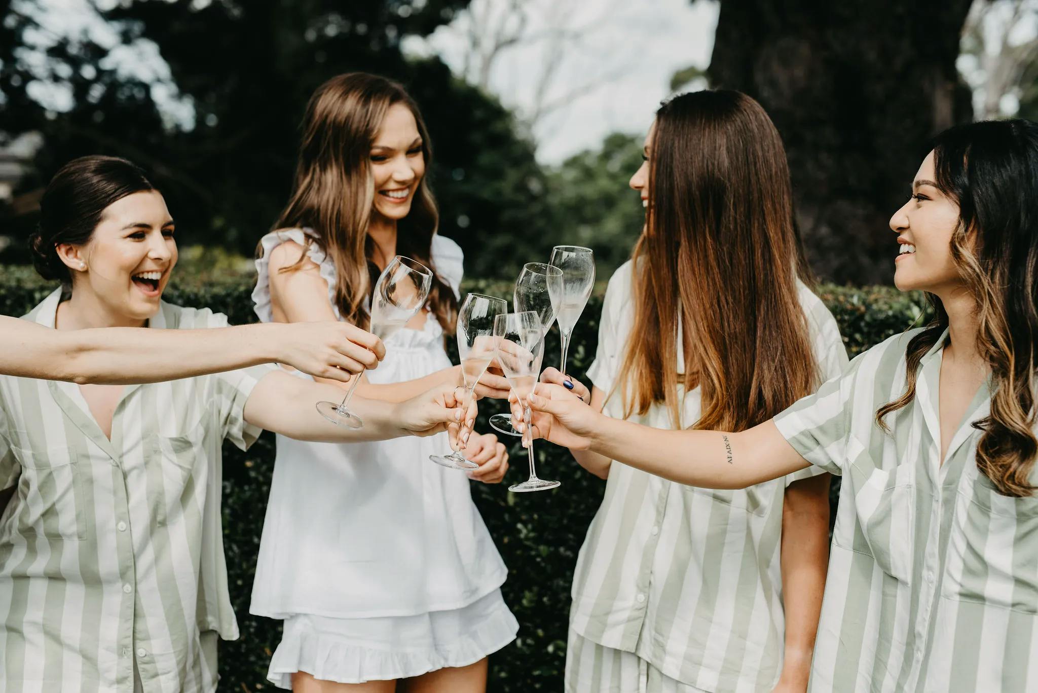 Bride and bridesmaids with champagne glasses