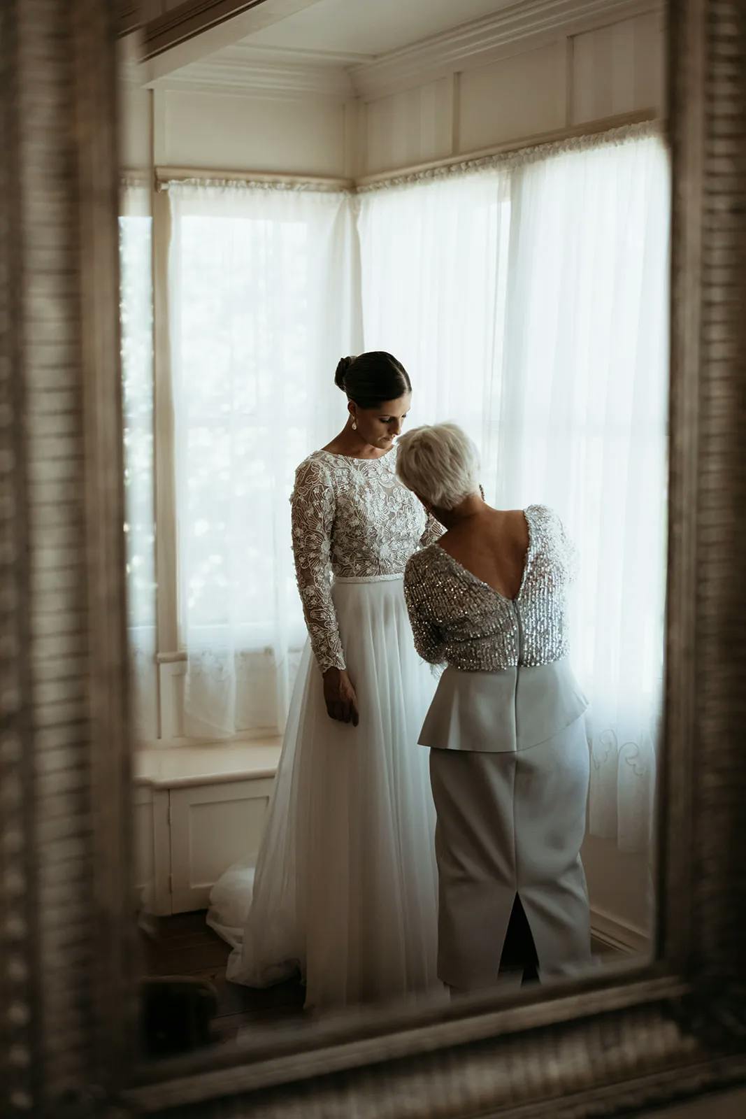 Bride and mother of the bride getting ready