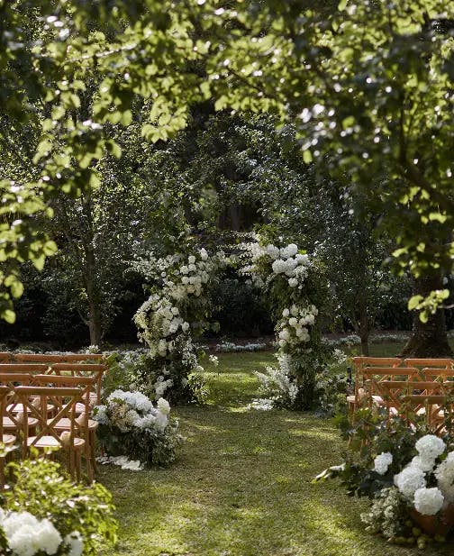 The Cedar Lawn Wedding Ceremony with white and green florals