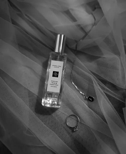 Perfume bottle on tulle with ring