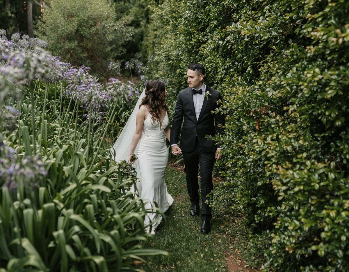 Couple walk amongst hedges