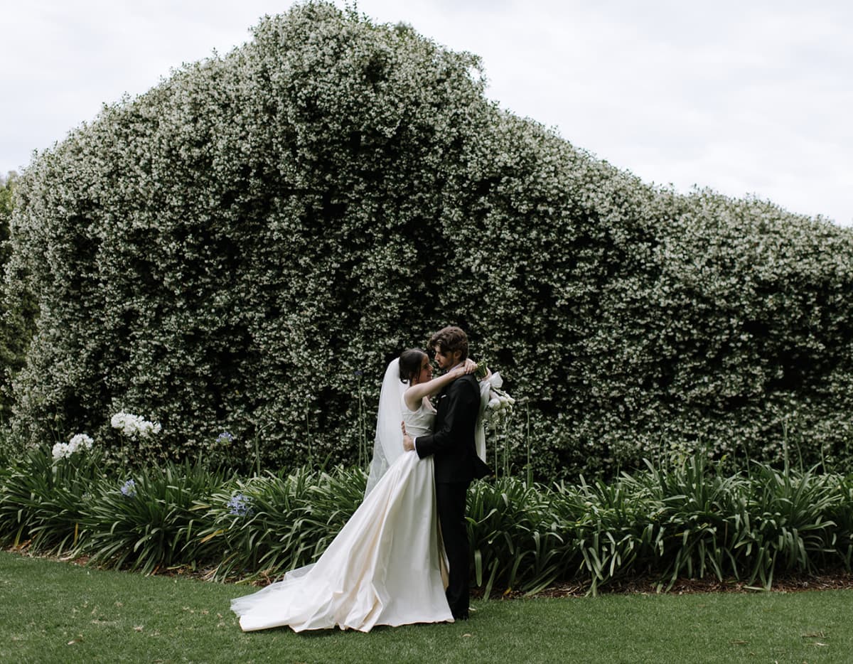 Couple kiss in front of stables