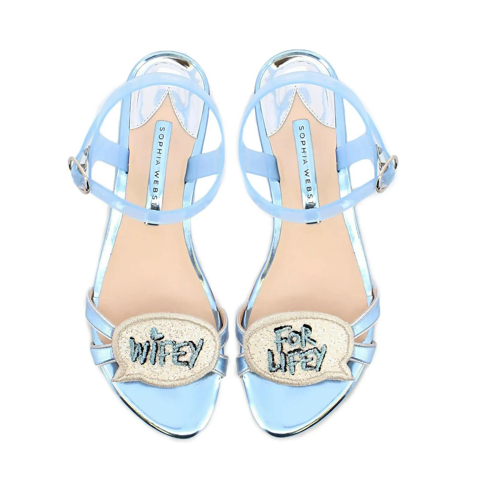 A pair of light blue strappy sandals with glittery speech bubble embellishments. The left shoe has "Wifey" and the right shoe has "For Lifey" written on the embellishments.