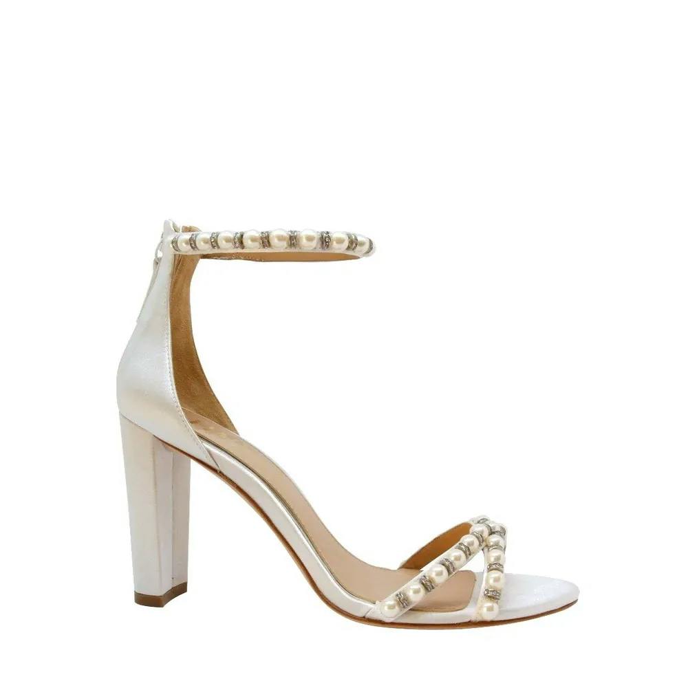 A high-heeled sandal with a metallic finish, featuring a block heel and ankle strap adorned with pearl-like studs. The open-toe design includes a similarly studded strap across the toes. The interior is lined with a tan material.