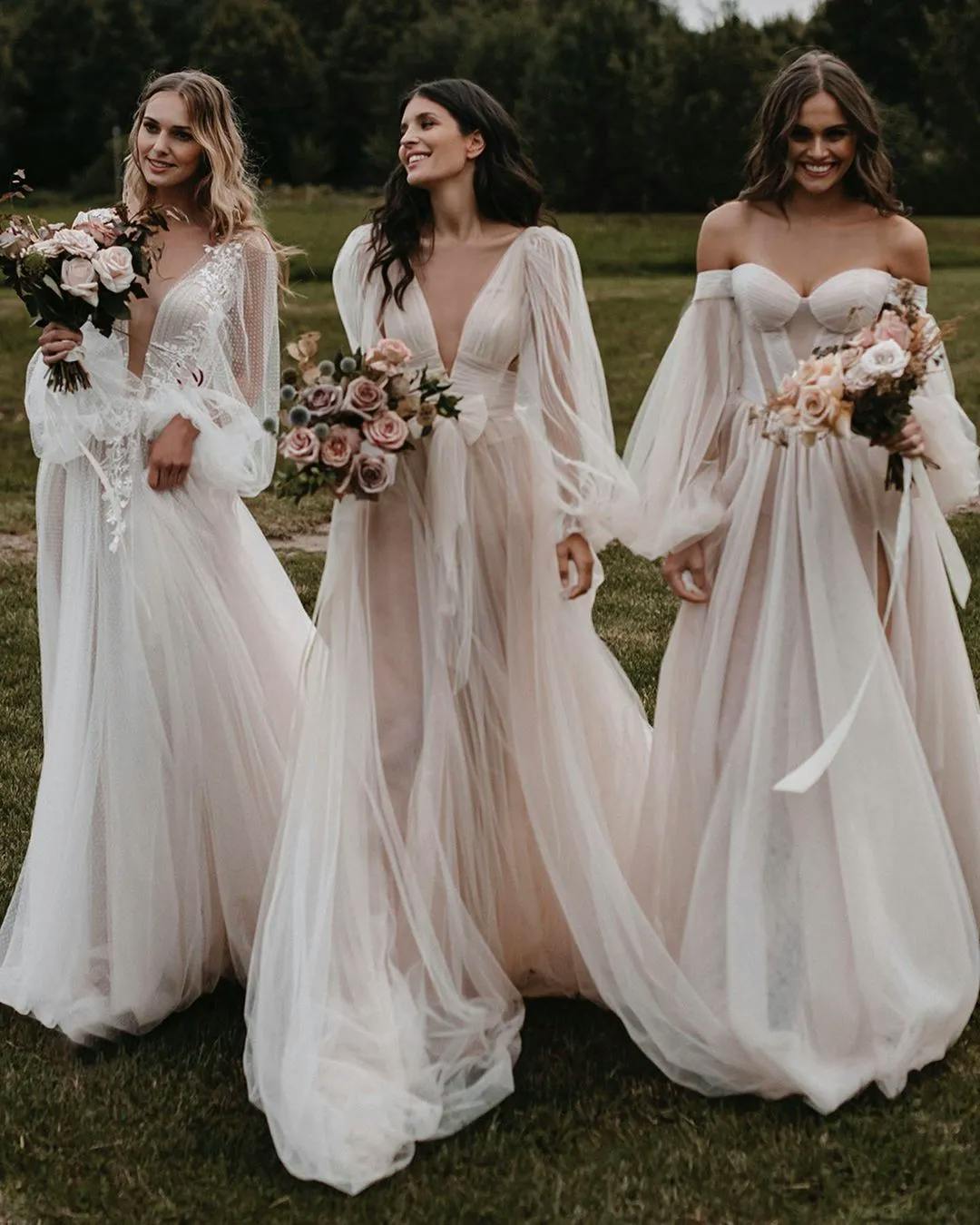 3 brides wearing flowing wedding dresses