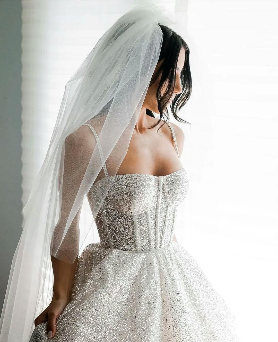 Bride wearing dress wiht corset and veil
