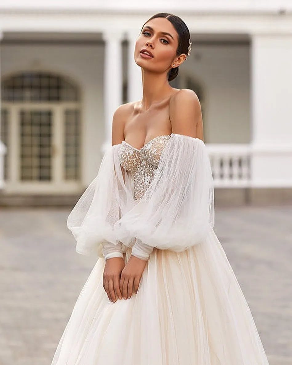 Bride wearing dress with corset and loose sleeves