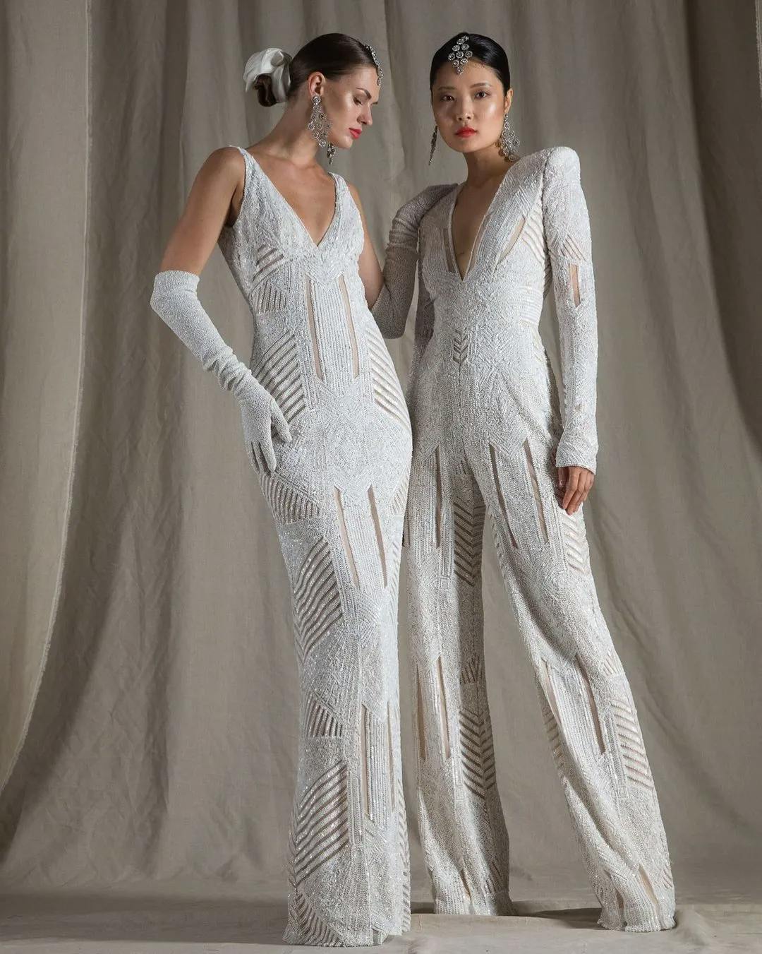Two brides, one wering a dress, one wearing a jumpsuit