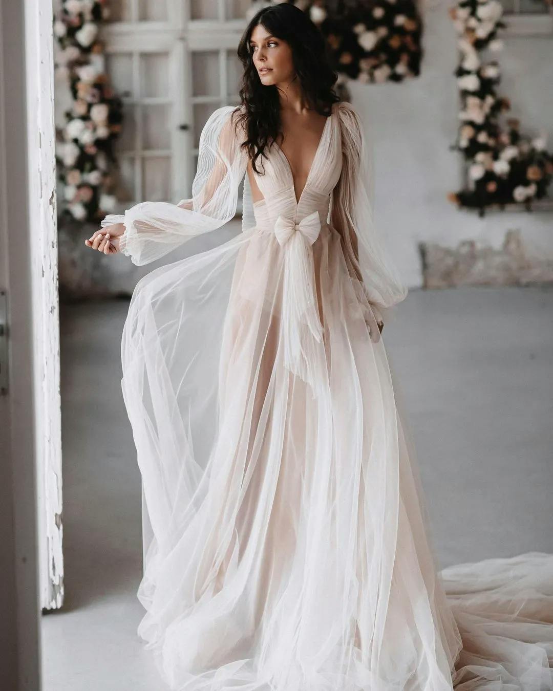 Bride wearing wedding dres with sheer lace and cutouts