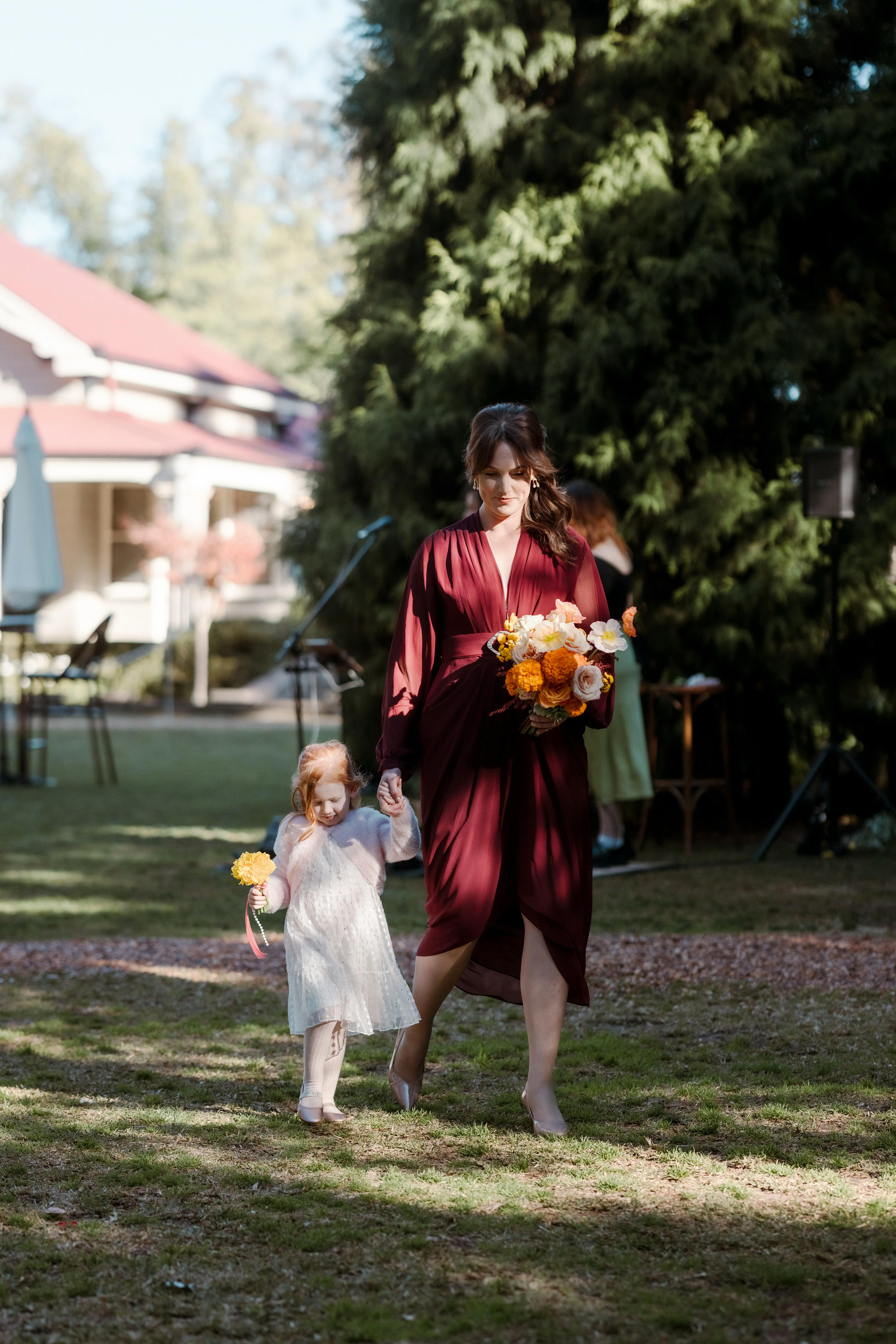 Bridesmaid and flowergirl walking down the aisle