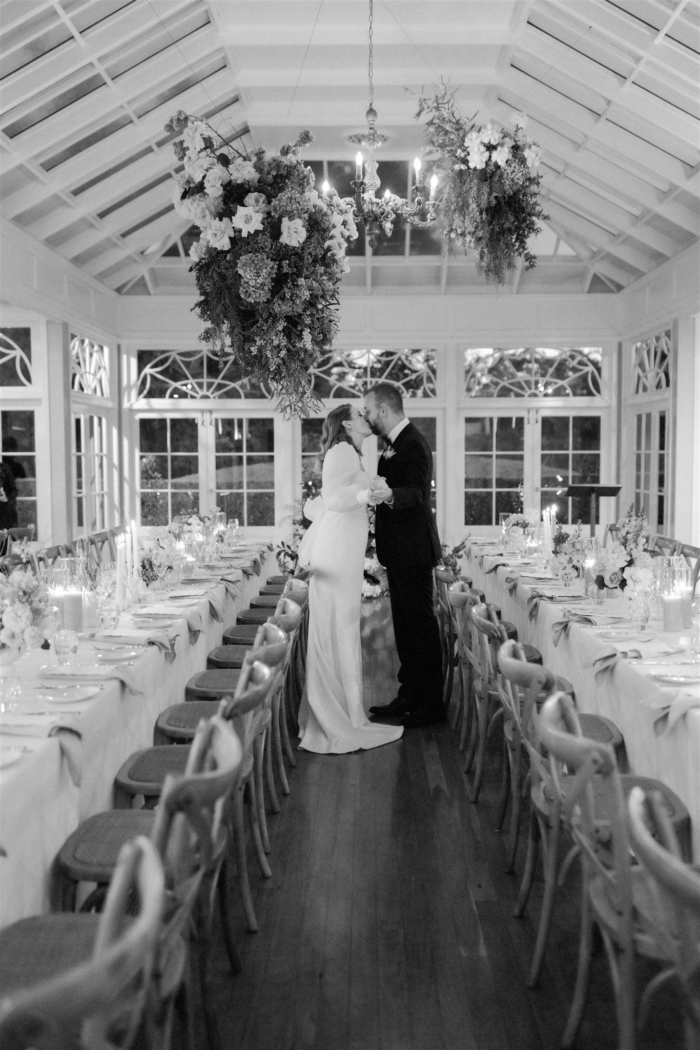 Bride and groom kissing in reception