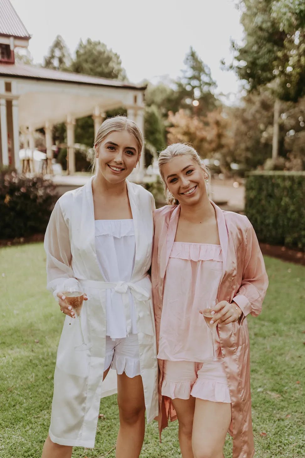 Bride and bridesmaid holding champagne