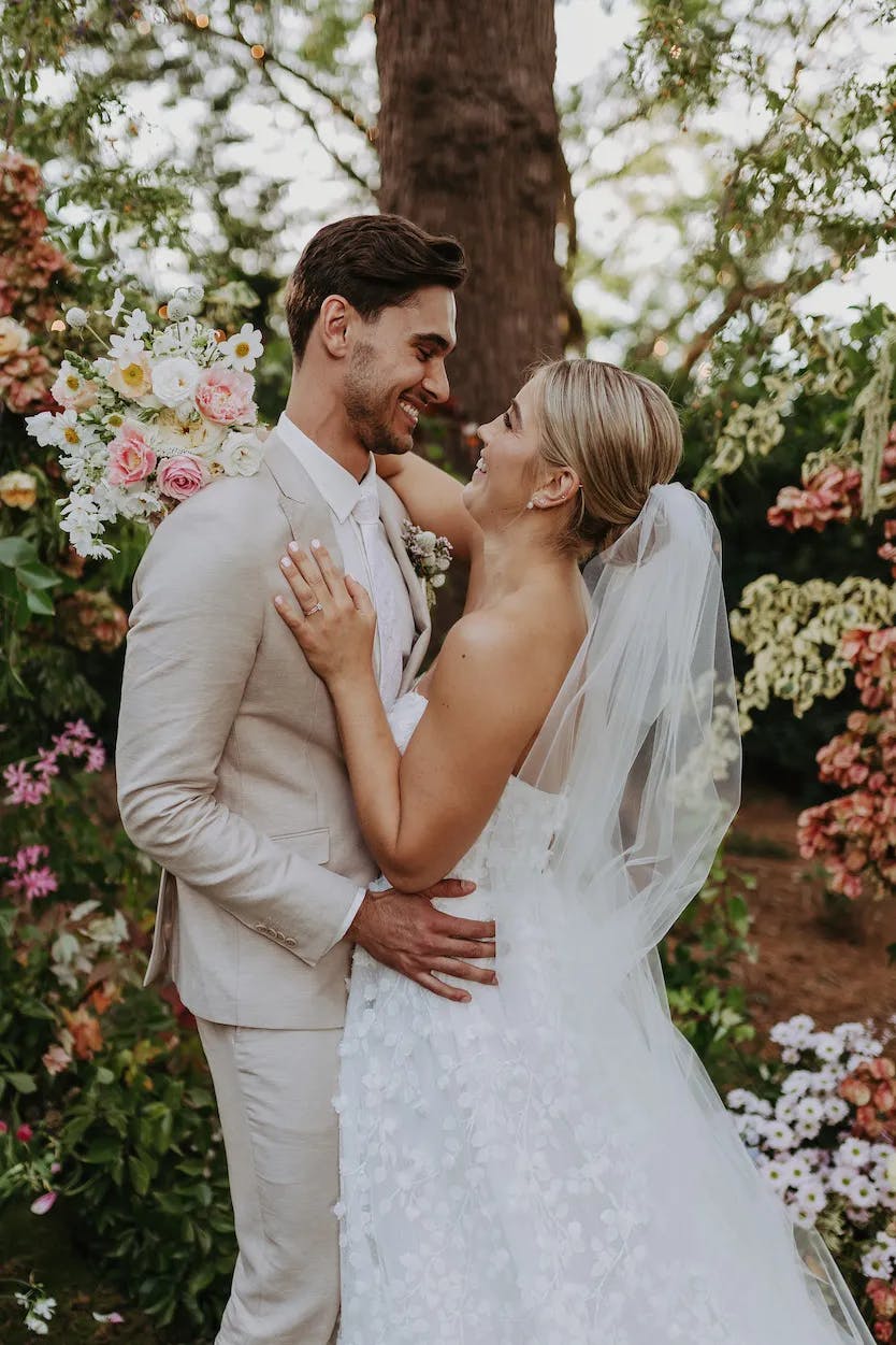 Bride and groom embracing at wedding altar