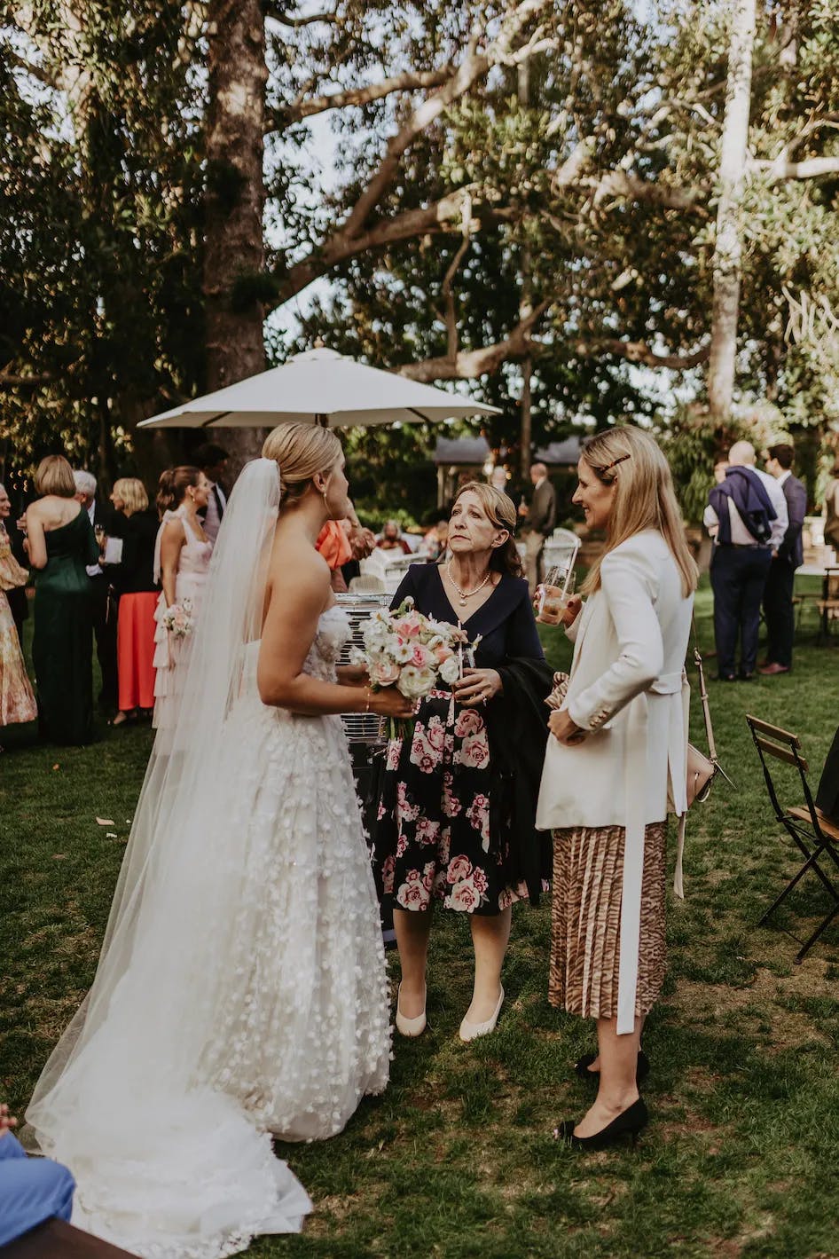 Bride talking to guests in garden party