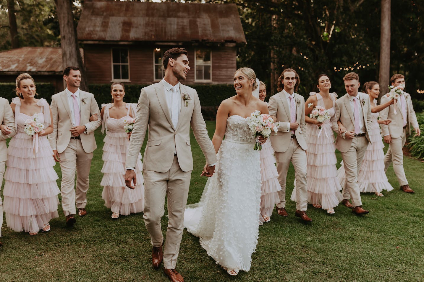 Bride and groom walking with wedding party