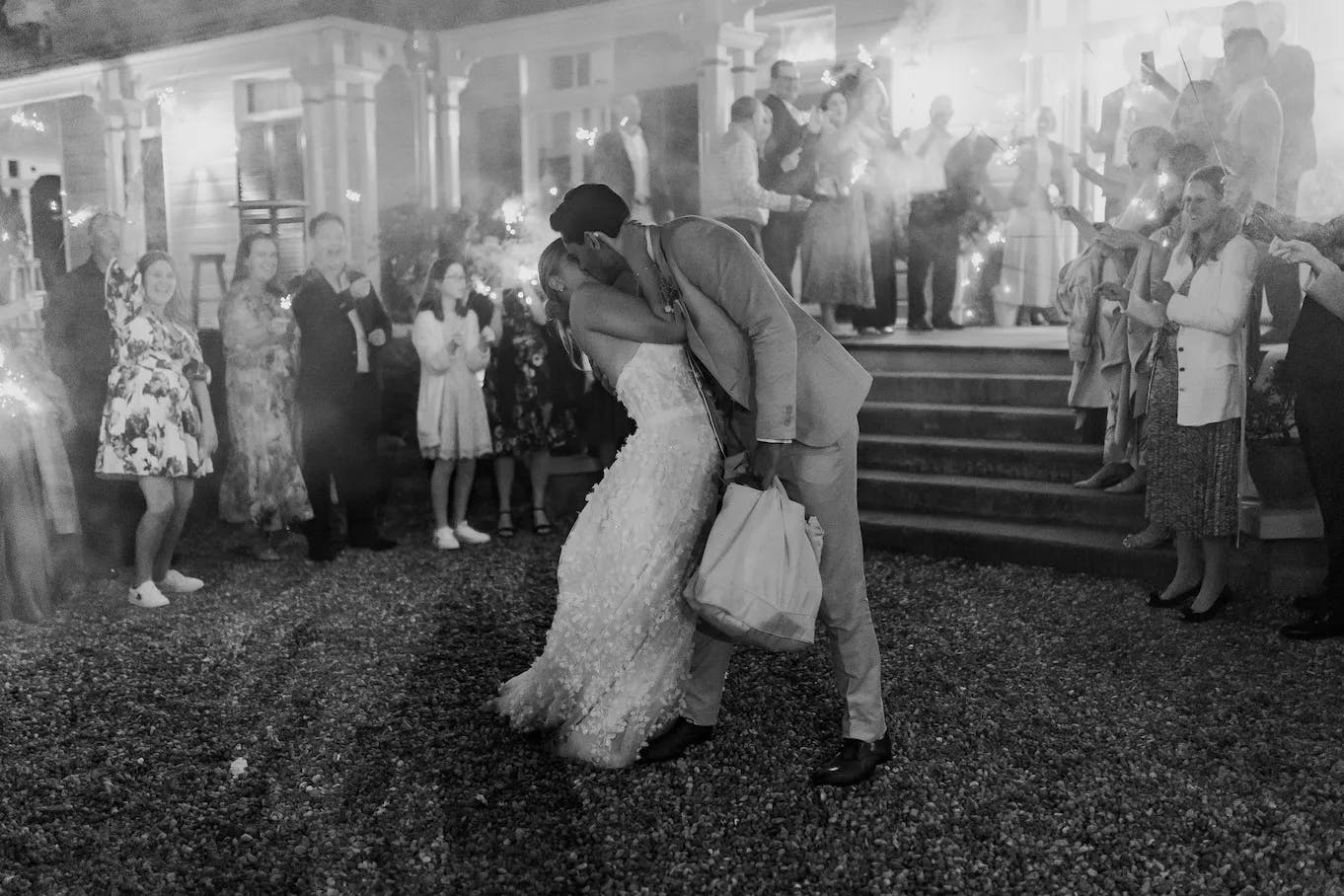 Bride and groom kissing amdist sparklers