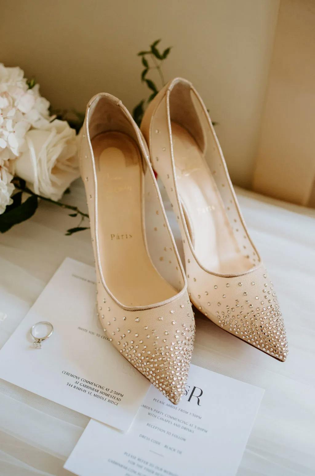 Brides wedding shoes and wedding invitations