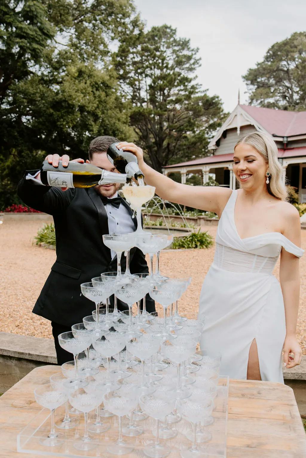 Bride and groom pouring champagne