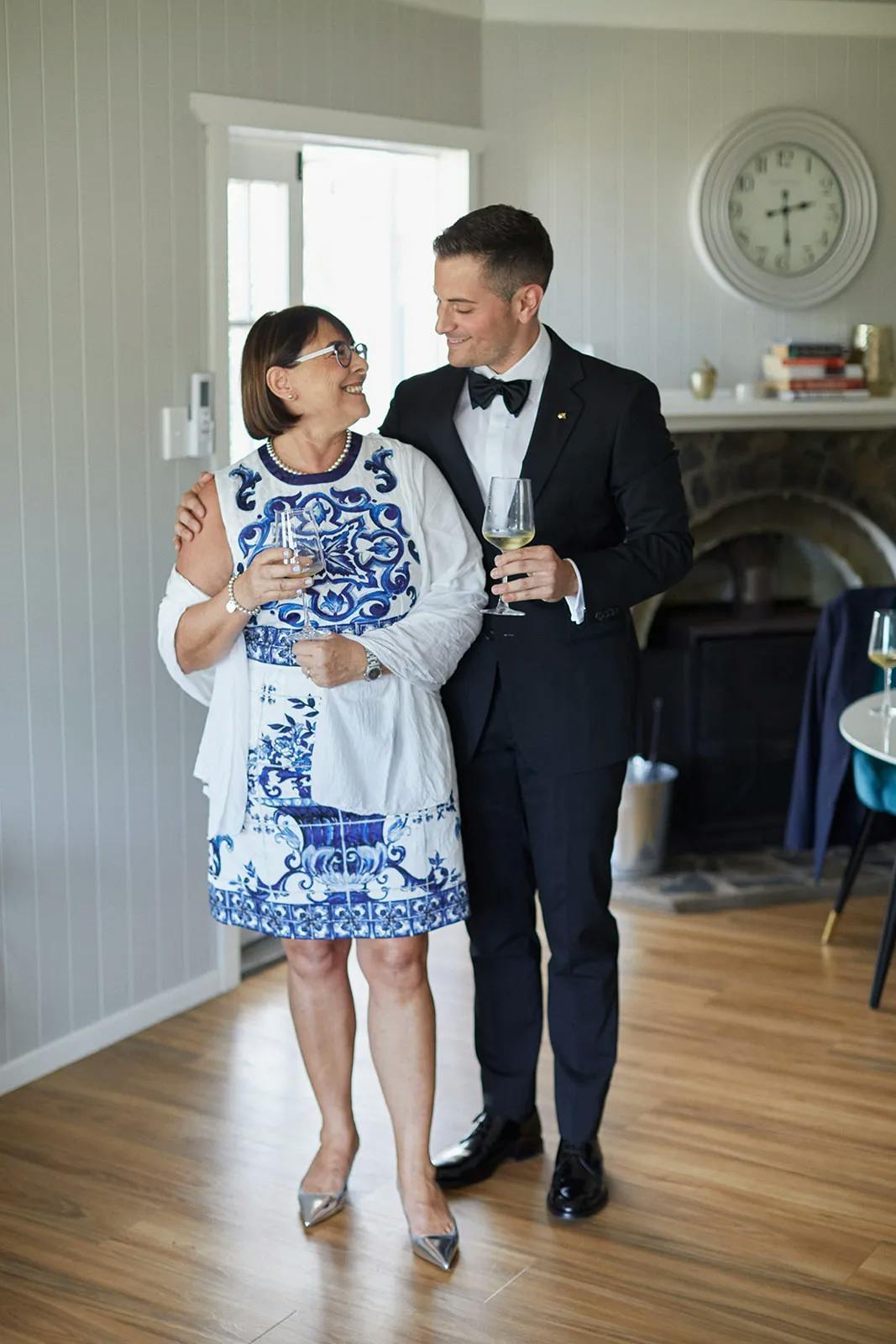Groom and mother of groom holding wine