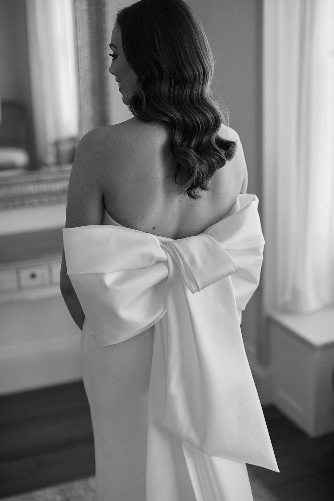 Bride wearing wedding dress with bow