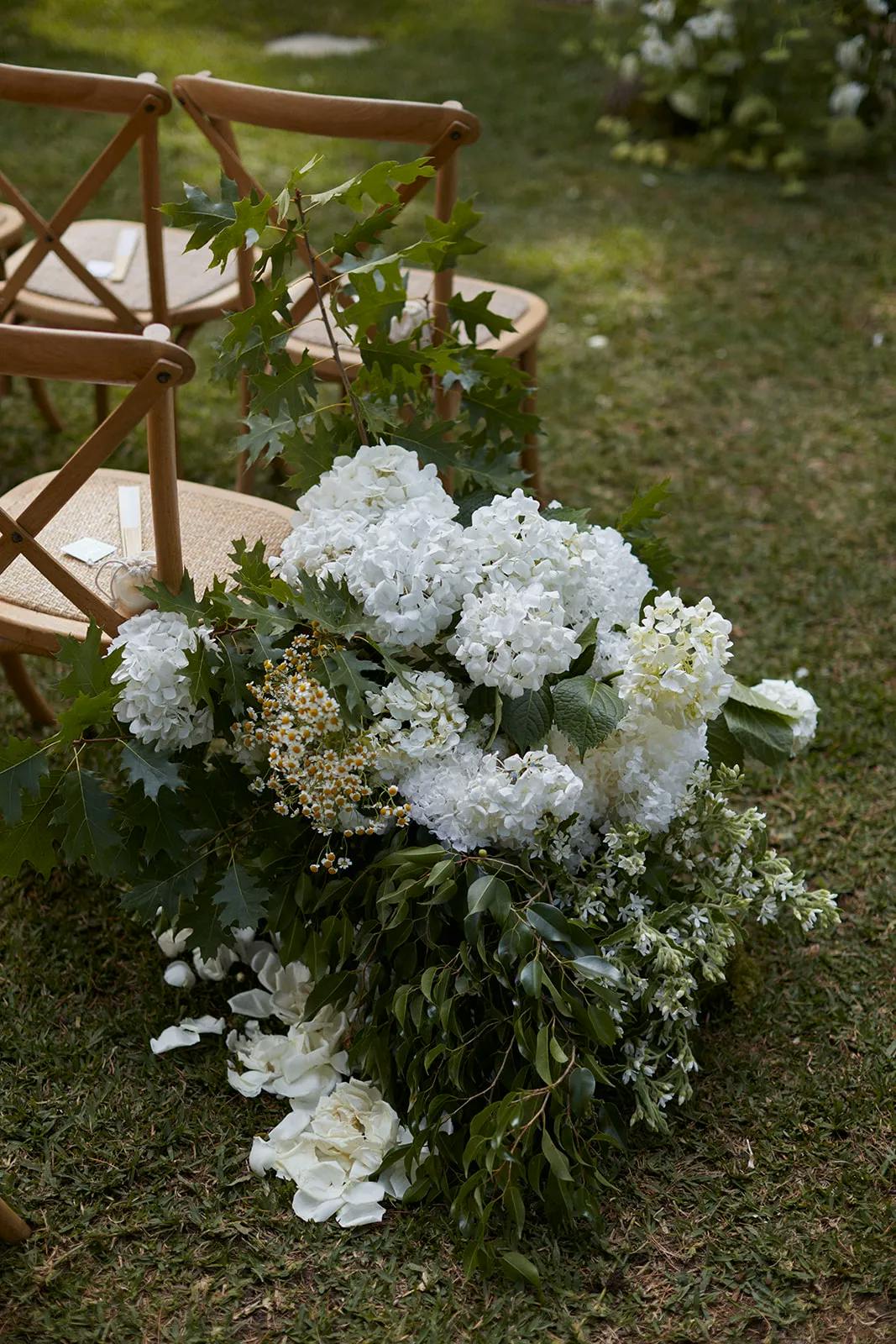 Wedding chairs with flowers by side