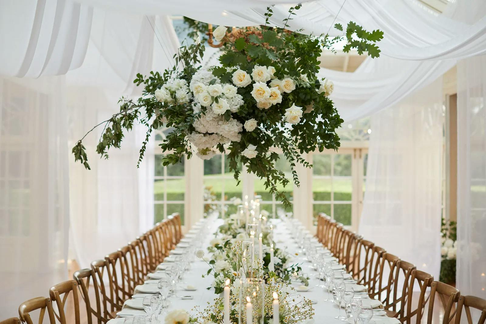 Wedding reception flowers and white draping linen