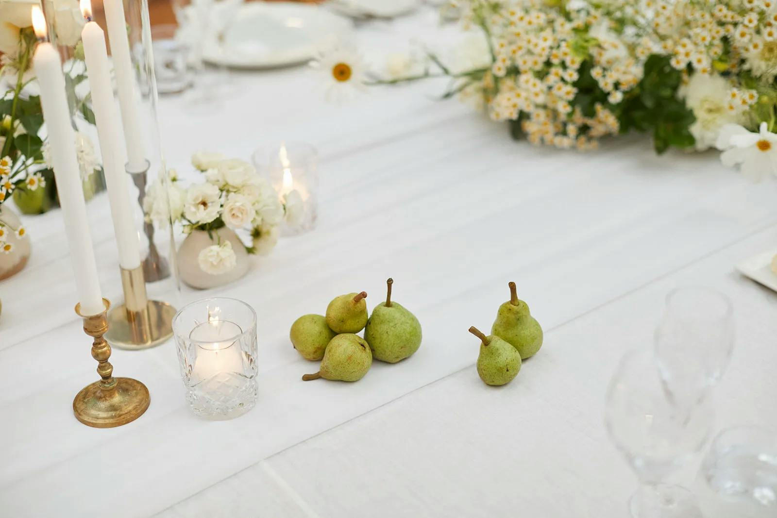 Wedding table with pears and flowers on it