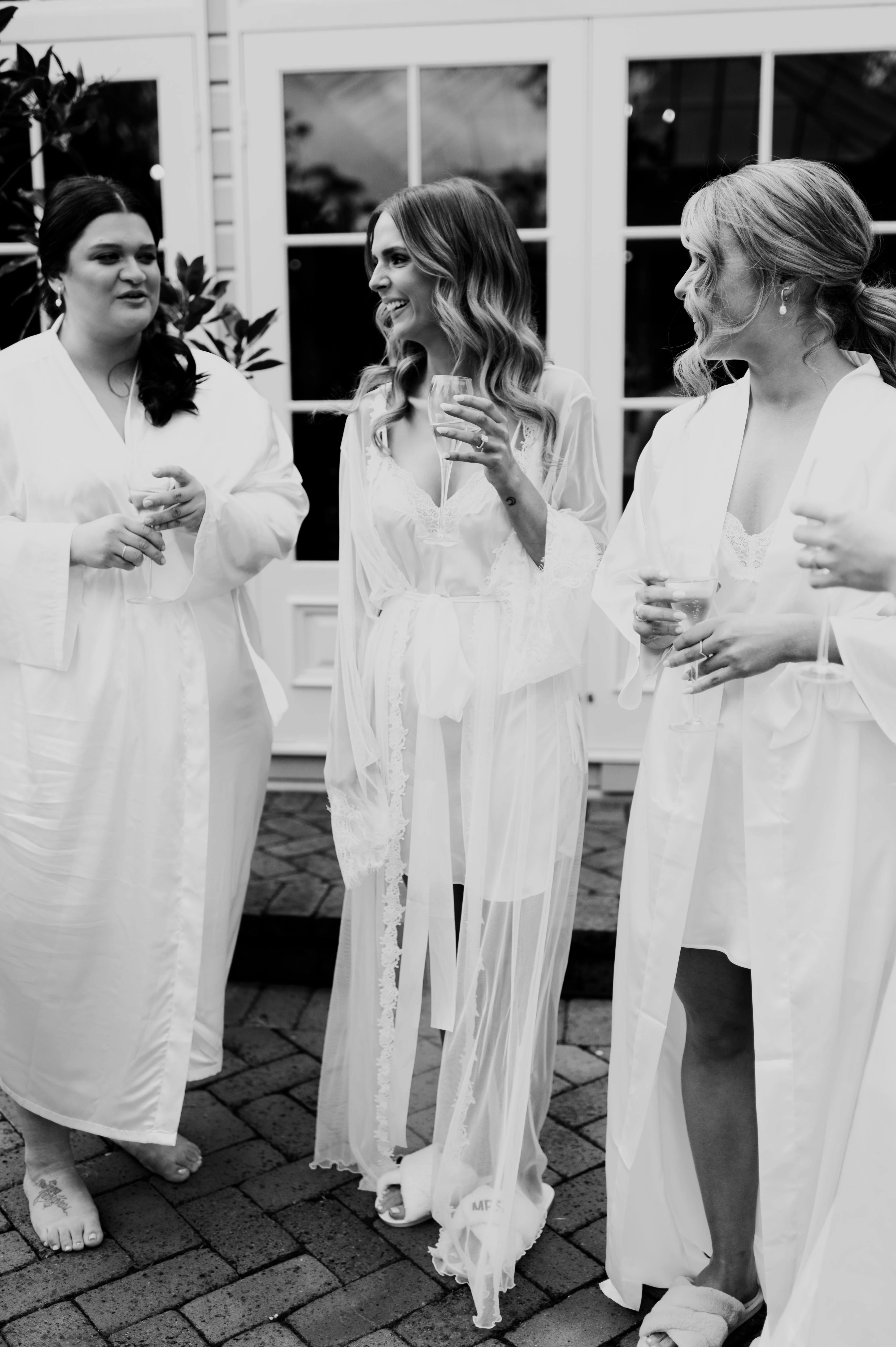 Bride drinks champagne with bridal party