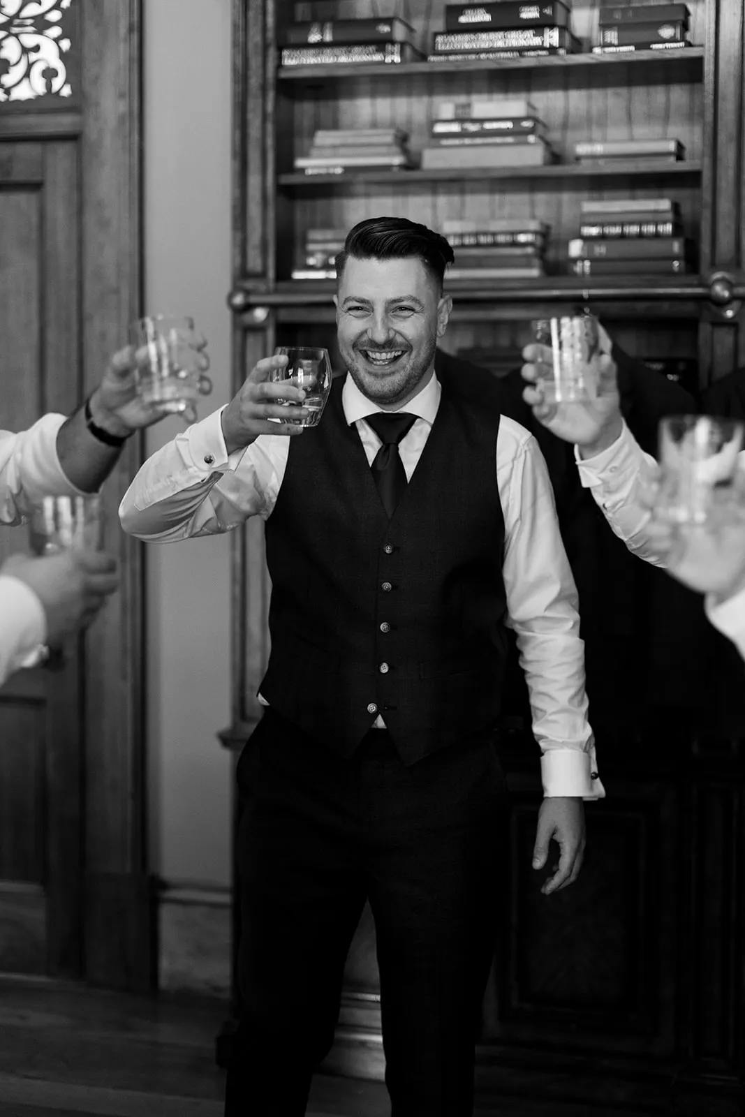 Groom drinking scotch and holding glass