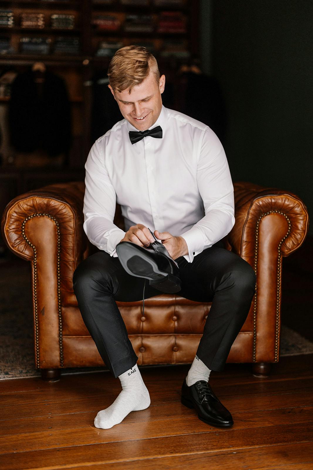 Groom putting on shoes