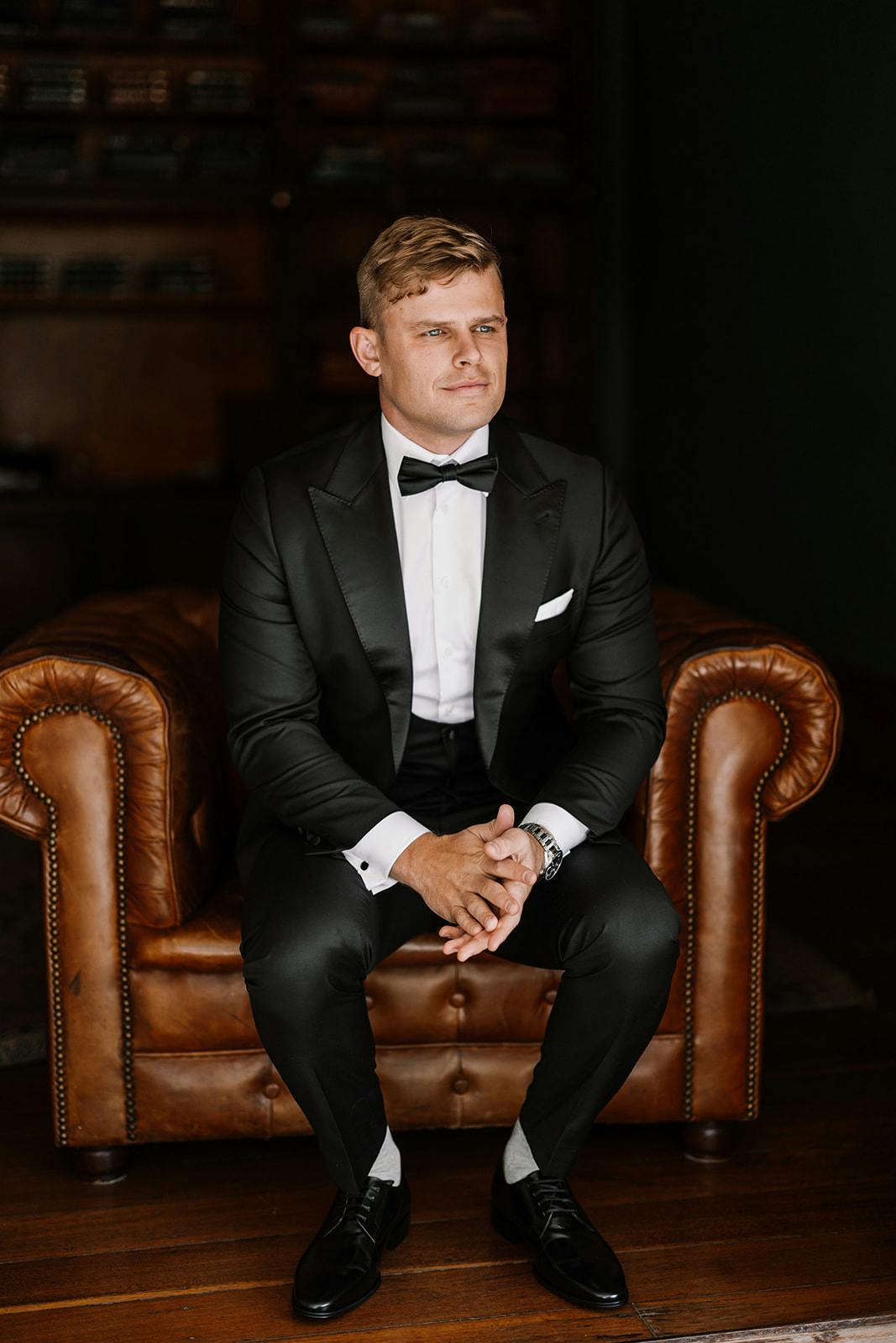 Groom sitting in leather chair