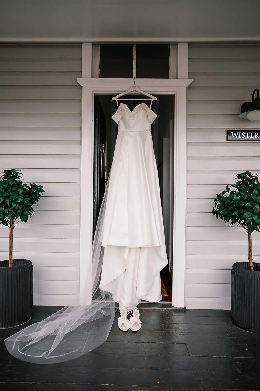 Bride dress hanging from doorway