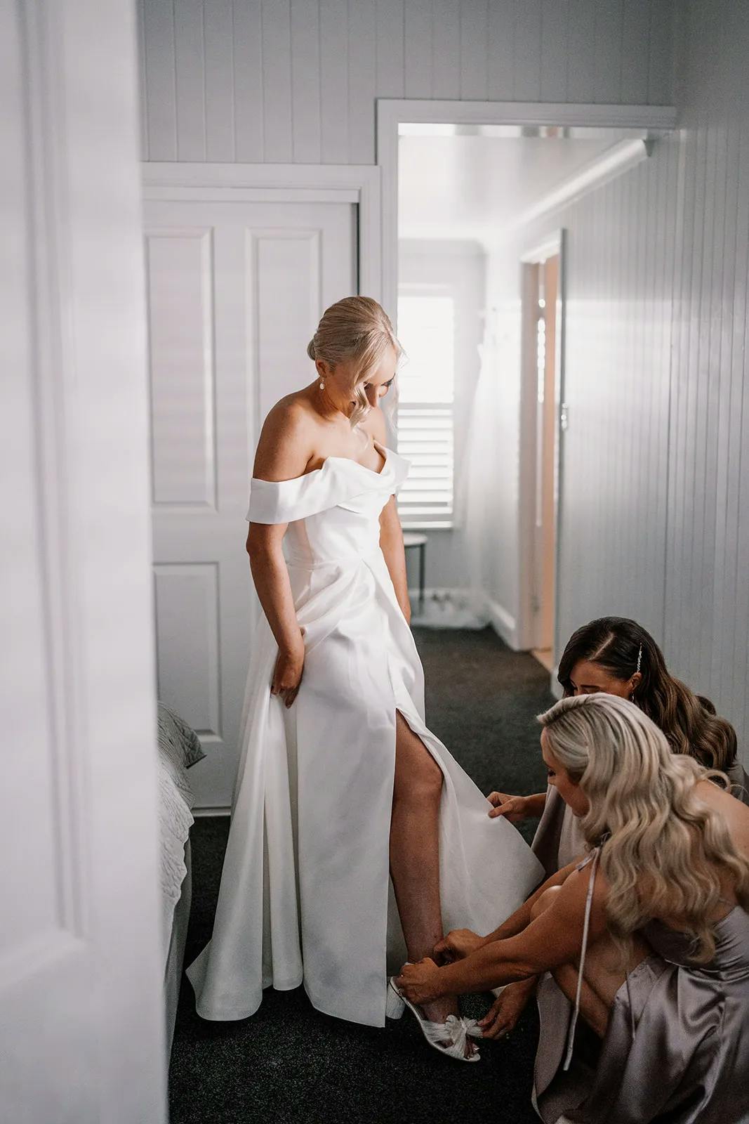 Bride having shoes done up