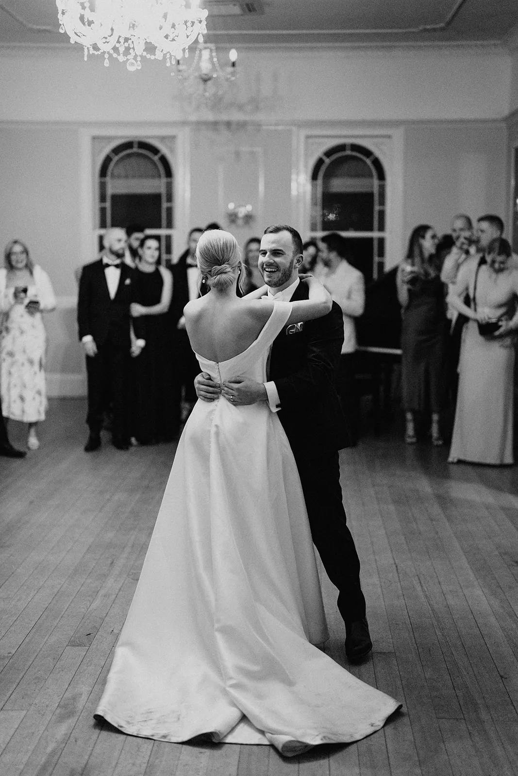 Bride and groom dancing in ballroom