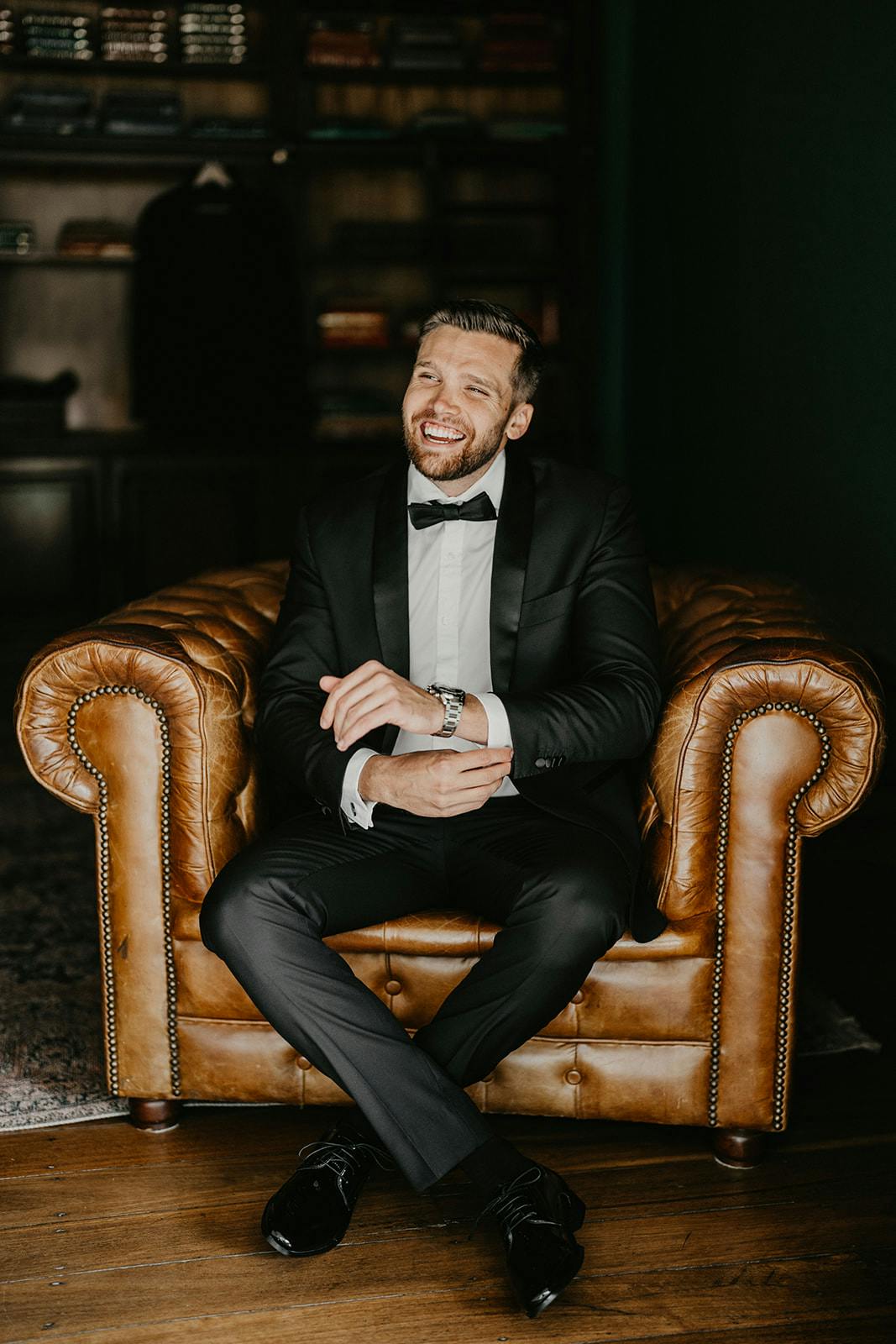 Groom sitiing in leather chair