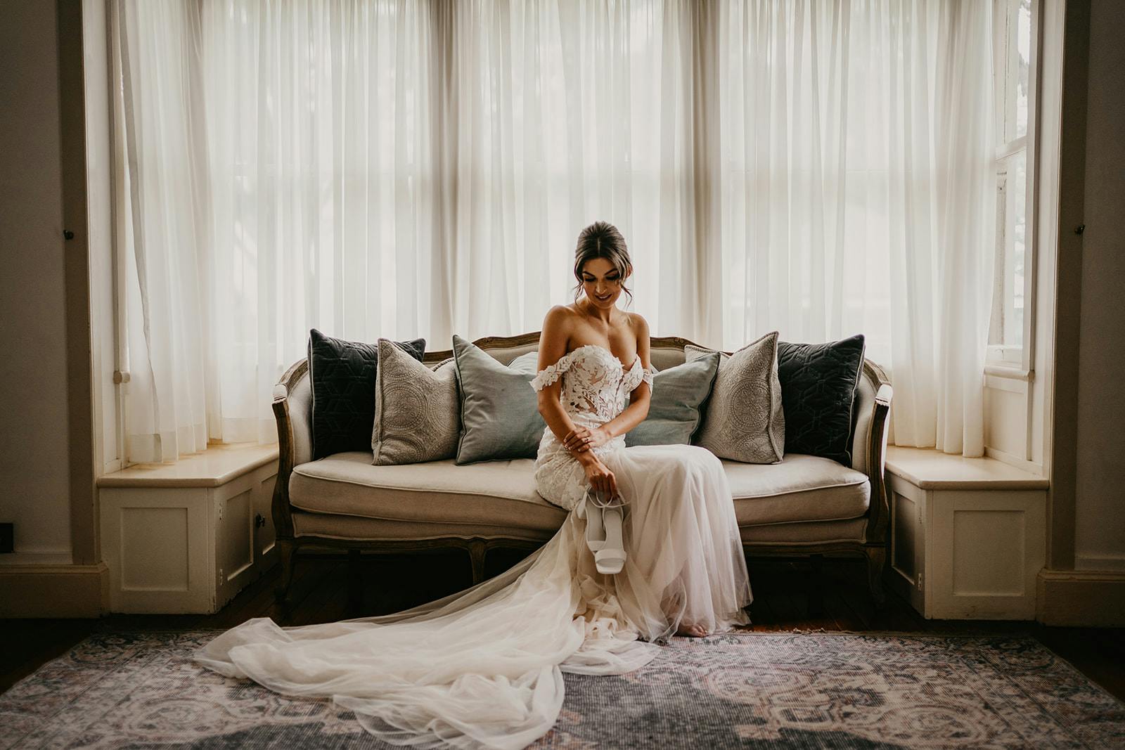 Bride sitting on chaise