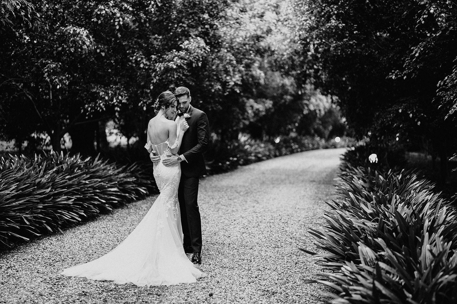 Bride and groom standing on driveway
