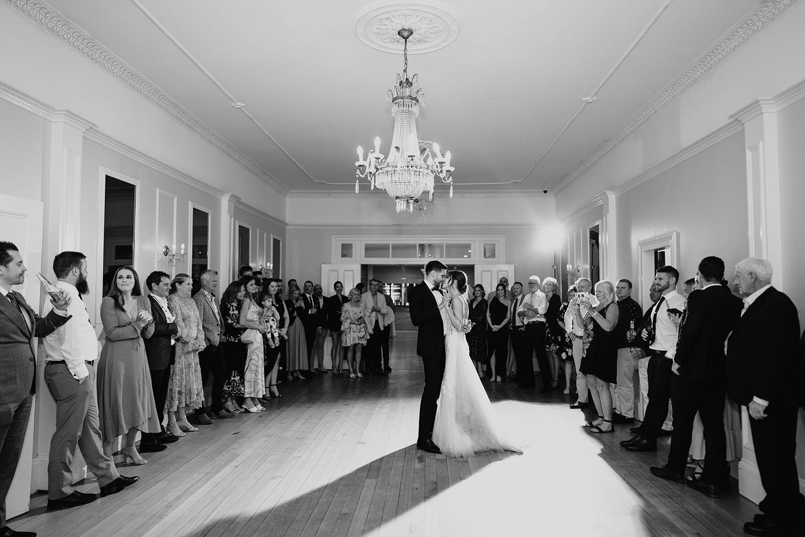 Bride and groom dancing in ballroom