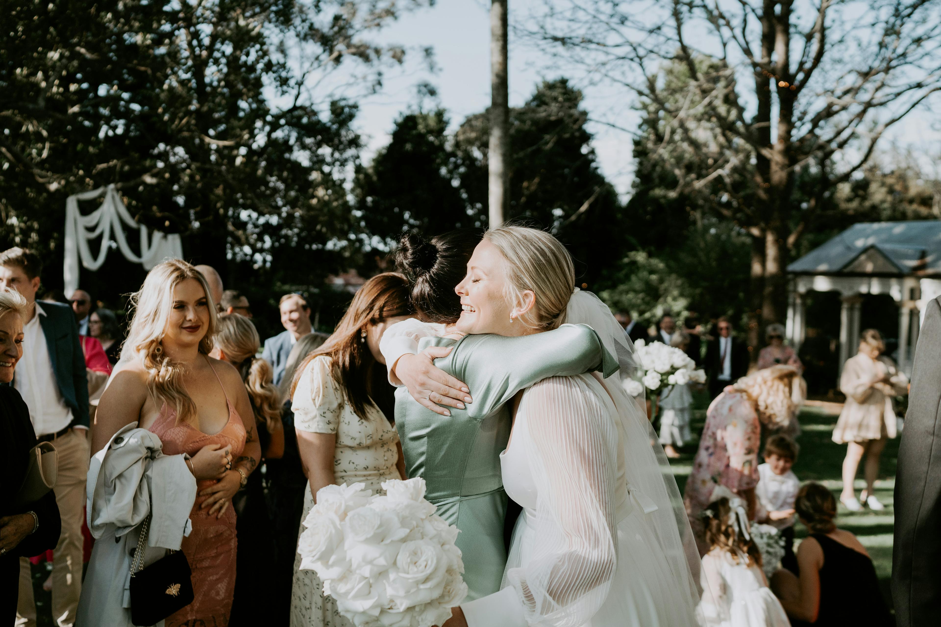Bride hugging wedding guest
