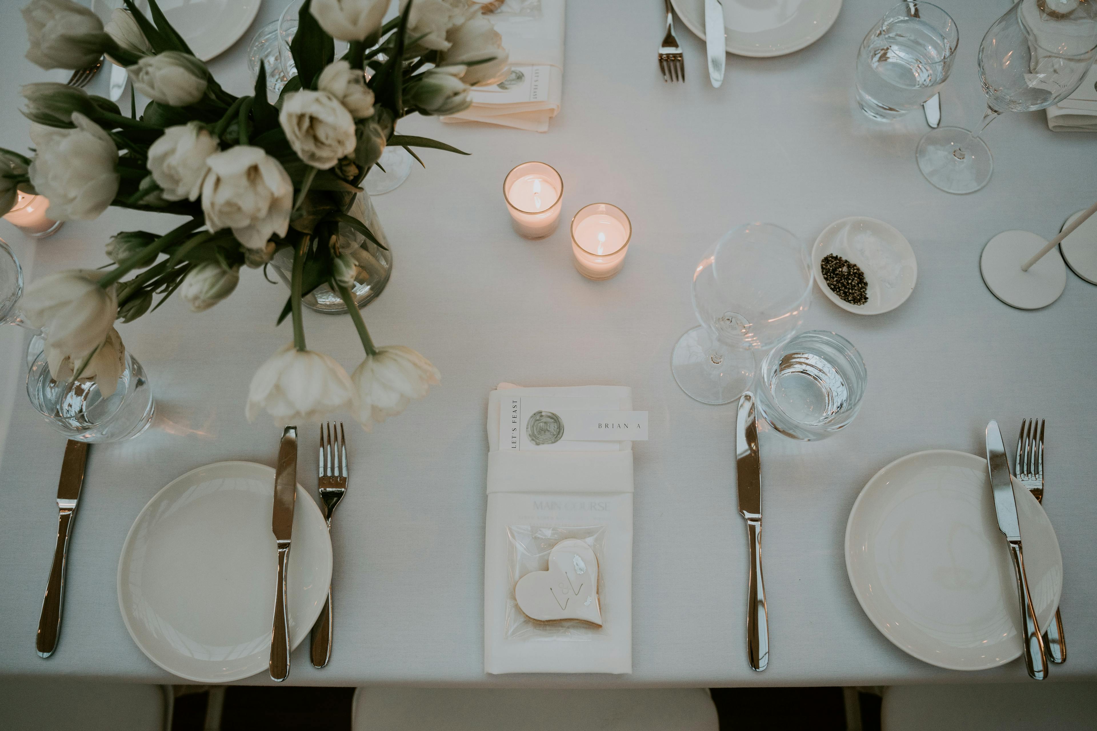Wedding reception set with cutlery and candles and flowers