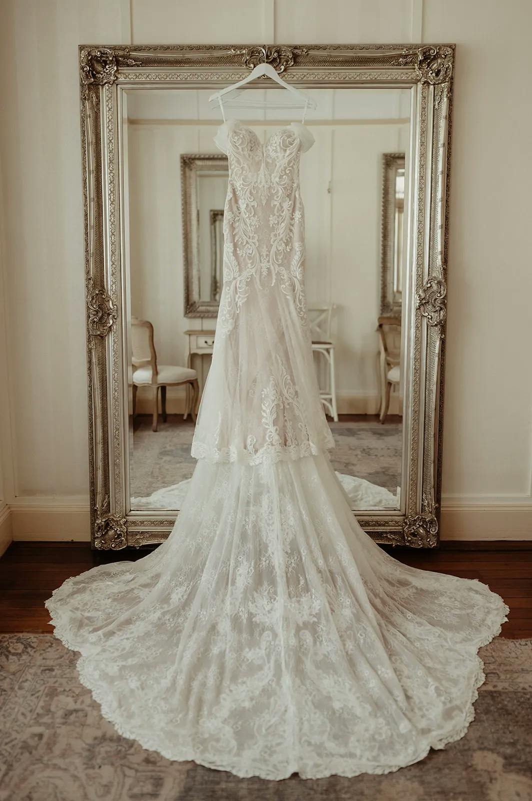 Wedding dress hanging on mirror