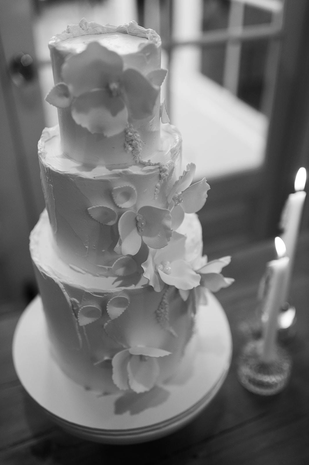 Wedding cake with two candles next to it