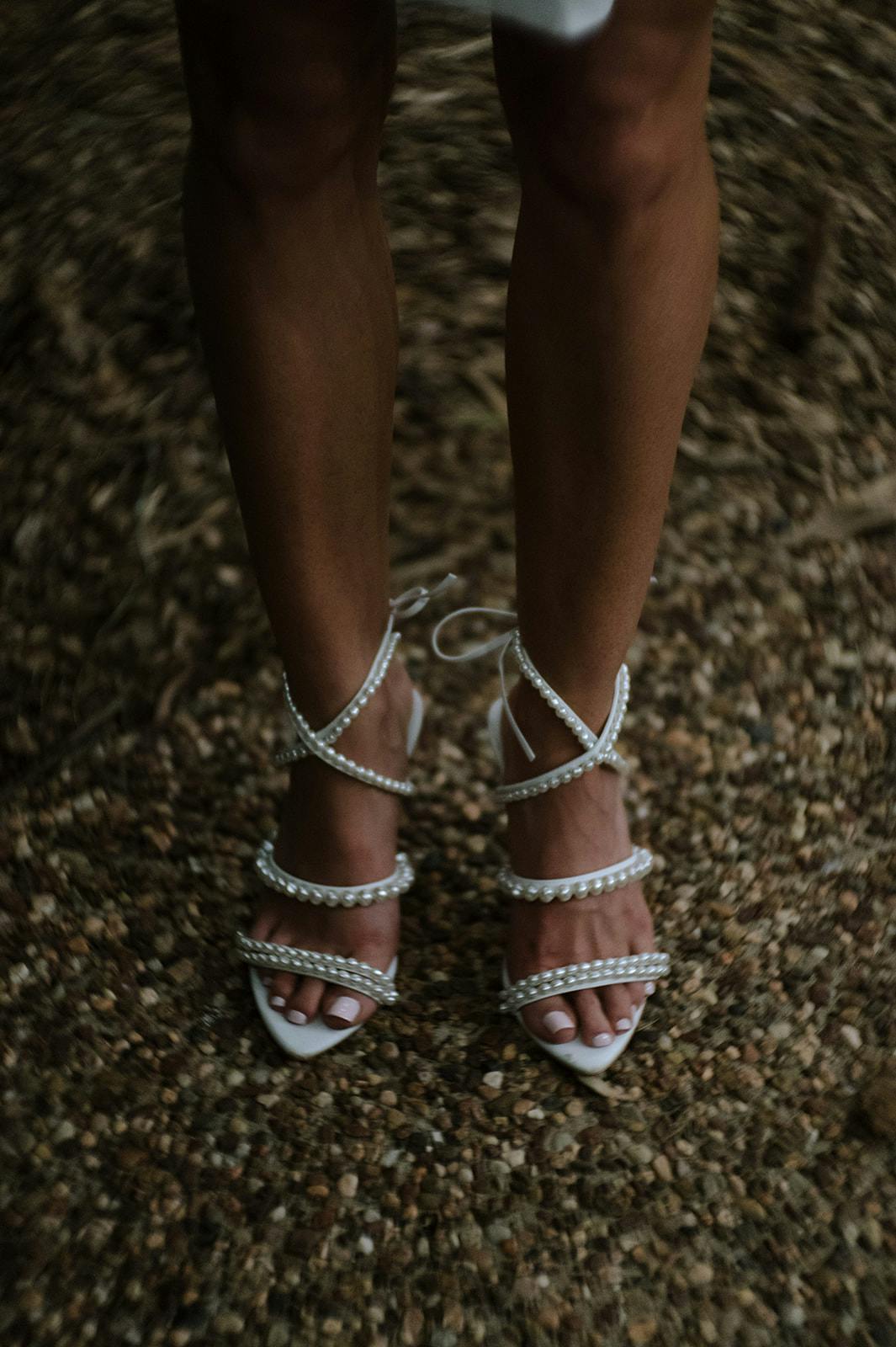 a photograph of a bride's wedding shoes
