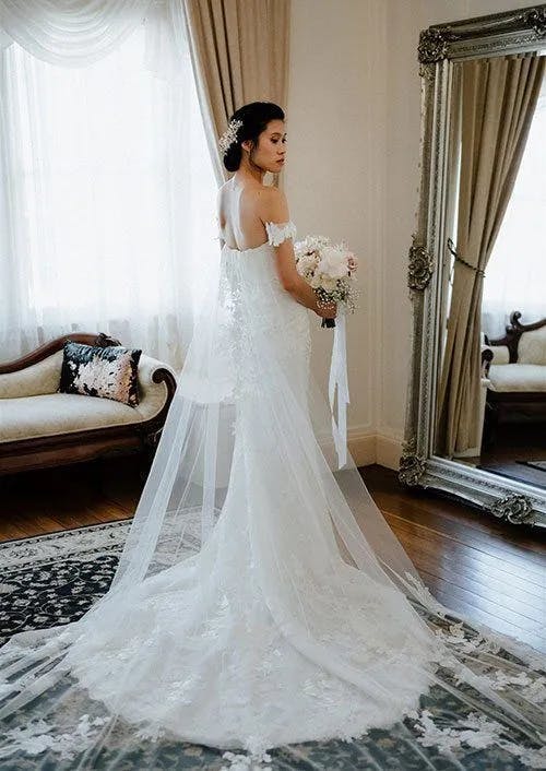 a beautiful bride posing for a photograph holding her wedding bouquet