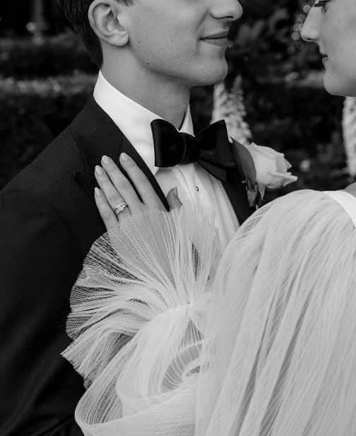 Bride's sleeve as she touches groom