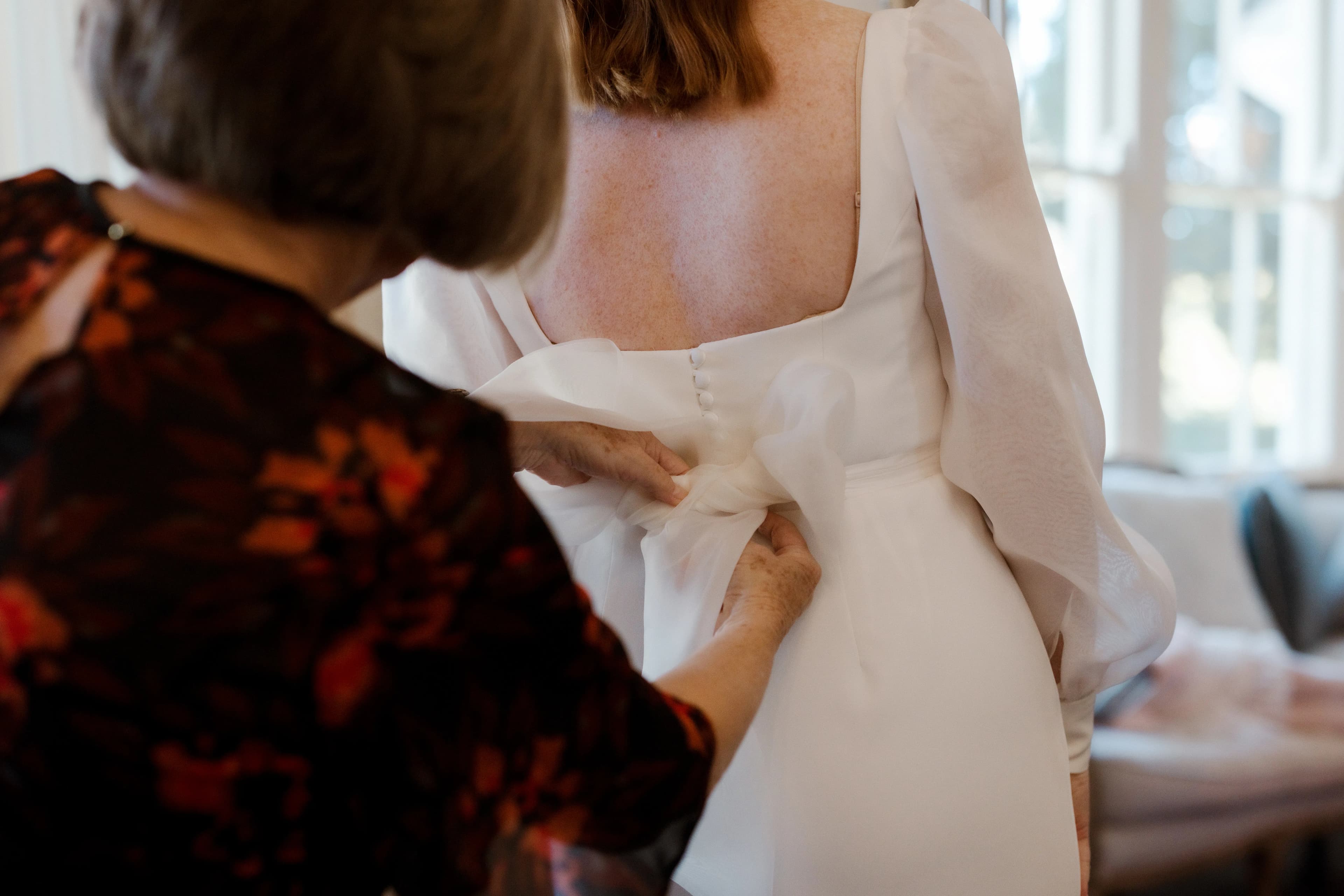 Bride getting into dress