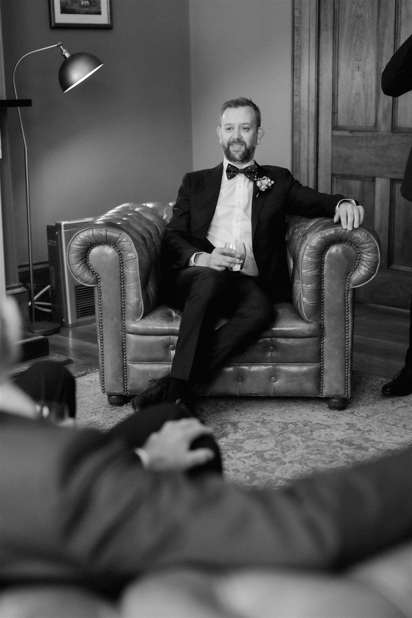 Groom sitting in leather lounge