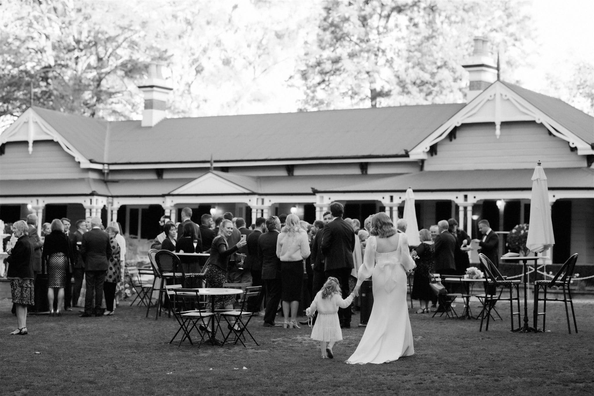 Bride holding daughters hand and walking