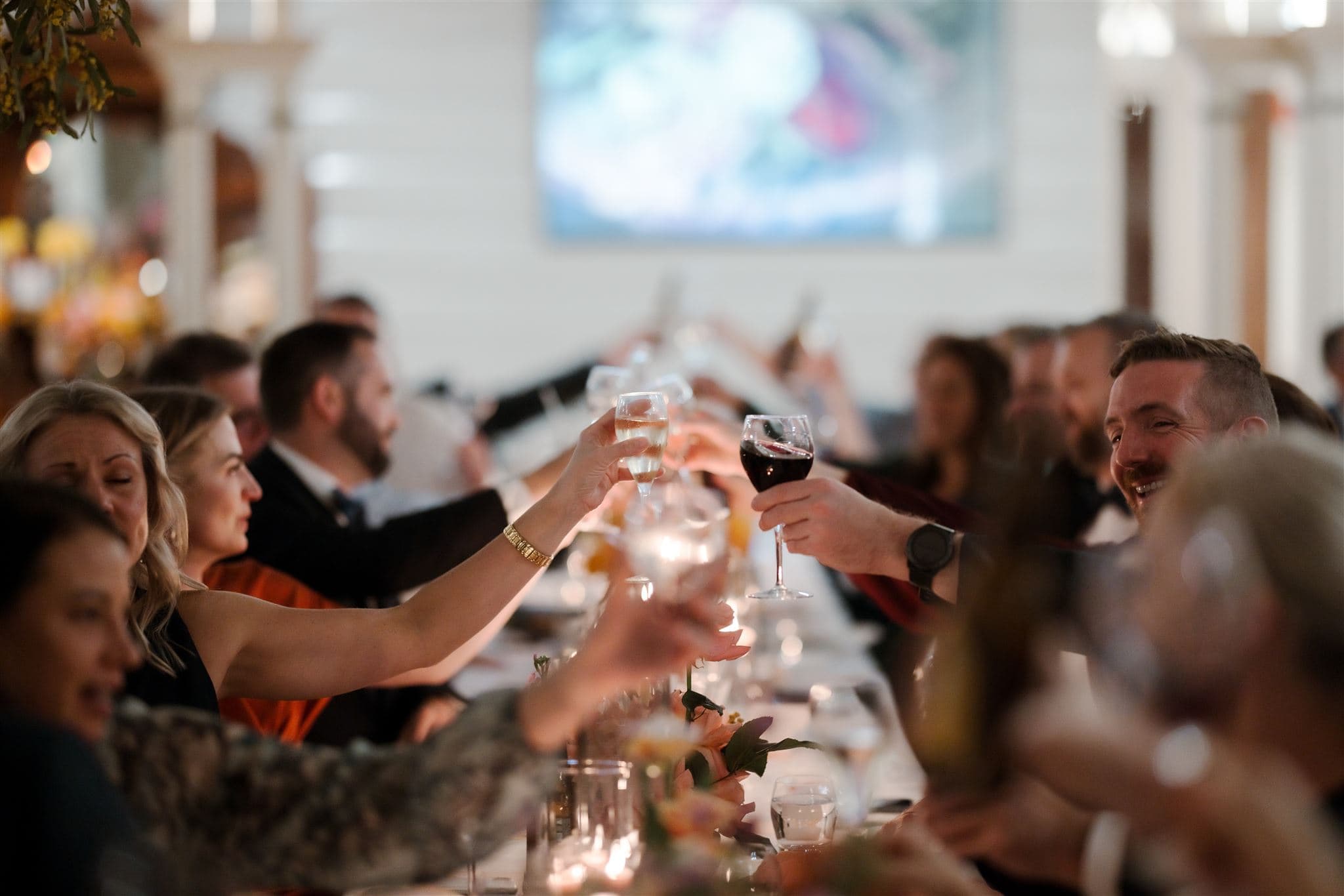Guests raising glasses for toast at a wedding