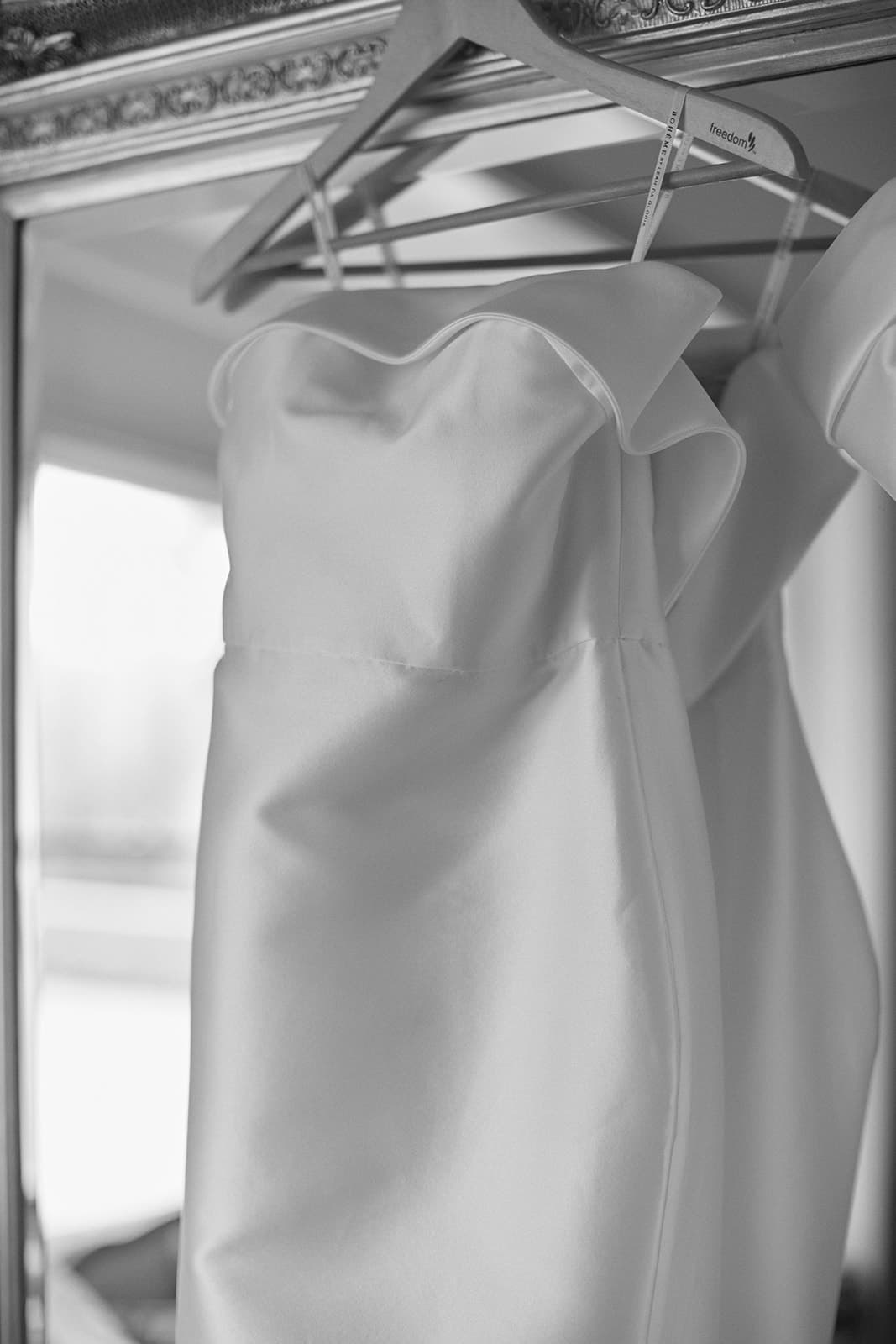 Wedding dress hanging on mirror